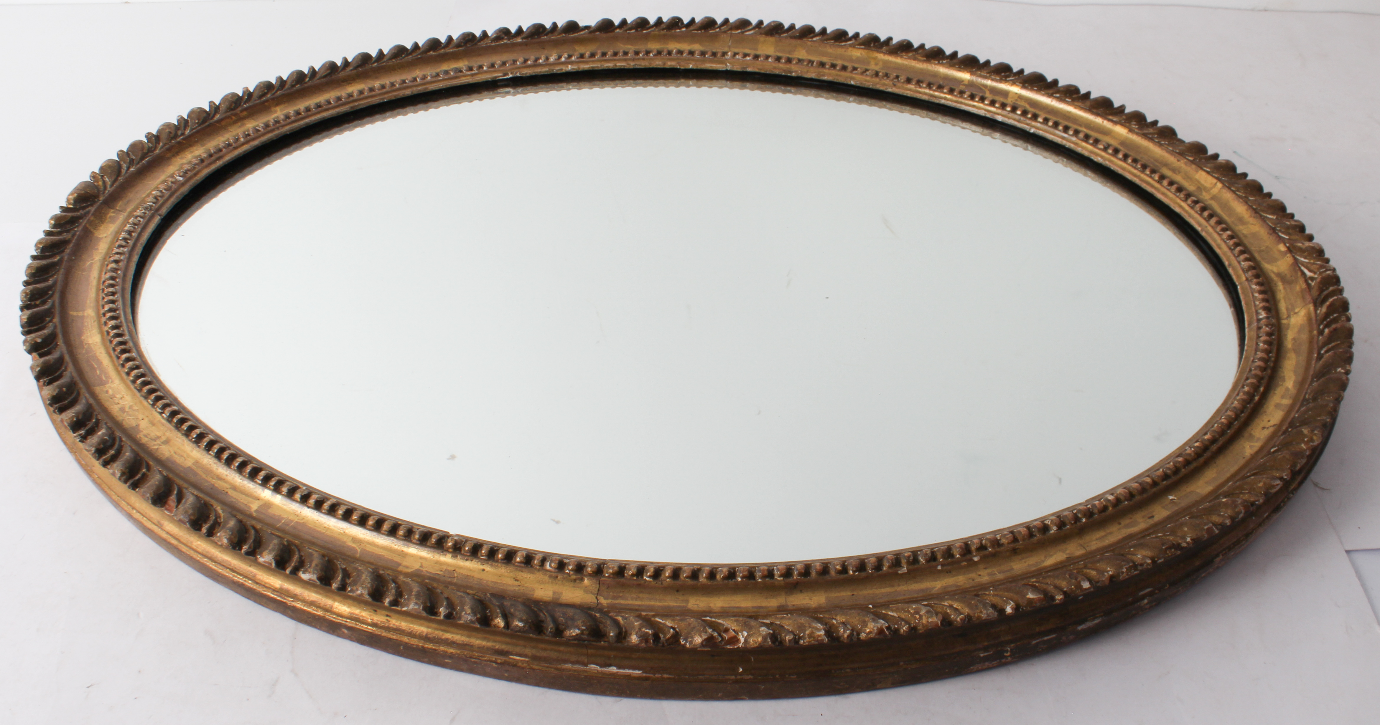 An oval gilt and composition mirror - the late 19th century frame with gadrooned border and shot - Image 2 of 2