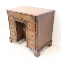 A mid-18th century style (later) mahogany kneehole desk: the thumbnail moulded top above a single