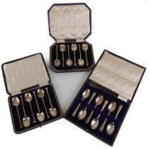 Three George V Art Deco period cased sets of six silver coffee spoons - two similar sets with