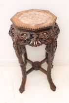 A late 19th century octagonal rosewood jardinière stand: the rouge variegated marble top with