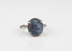 An 18ct white gold and opal triplet ring - stamped '18CT', the 11.5 x 10mm. oval cabochon opal