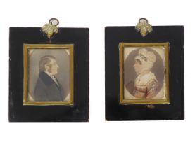 A pair of late-Regency portrait miniatures - watercolour on card within painted ovals, depicting a