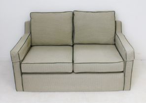 A 1930s style two-seater sofa - late 20th century, the low, rectangular back over downswept