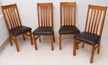 A set of four modern honey oak and faux leather dining chairs - the rectangular backs with four