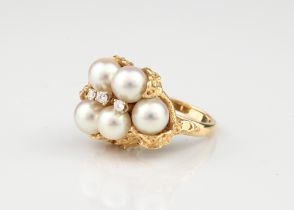 A vintage 14ct pearl and diamond ring - stamped '14K', the asymmetric, foliate effect setting with