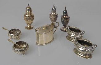 A small collection of silver, white metal and silver plated condiments - including an Edwardian oval