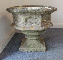 A reconstituted stone octagonal font on pedestal base - in the Gothic revival style, 66cm. diameter,