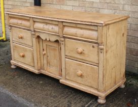 A Victorian waxed pine inverted breakfront dresser base - the nailed two-plank top over three