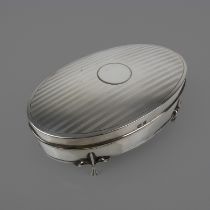 Oval silver jewel casket with engine-turned top standing on three-toed feet: hallmarked Birmingham