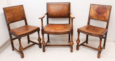 A set of three oak and tan leather chairs - 1920s, including one open armchair, with brass studded