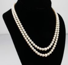 A vintage double-strand cultured pearl necklace - 1960s, the pearls graduating from 7.5mm. to 4mm.