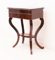 A French Charles X mahogany work-table: the hinged rectangular top enclosing a fitted satinwood