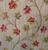 A pair of curtains with tie backs in a heavy tapestry effect fabric; triple pinch pleat heading,