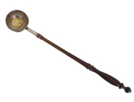 A Georgian silver toddy ladle - the cauldron shaped bowl with inset silver gilt Queen Anne 1708 coin