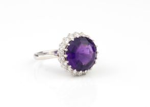 An 18ct white gold, amethyst and diamond cluster ring - stamped '18CT', the round, mixed cut