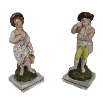 A pair of early 19th century Staffordshire pearlware figures emblematic of two of the Four Seasons -