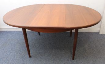 A G-Plan Fresco teak extending dining table - 1970s, the circular top with pull-out mechanism and