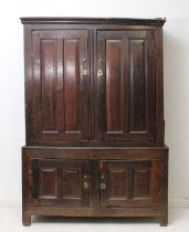 An early 18th century joined oak panelled livery cupboard - requiring some restoration, the flared