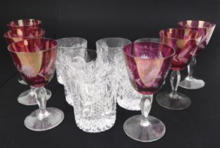 A set of six red overlay wine glasses and six heavily cut whisky tumblers.