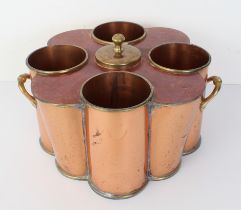 An early 20th century four-bottle two-handled copper and brass-mounted wine cooler with central