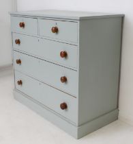 A 19th century grey-painted chest of drawers: two short over three long graduated drawers with