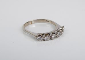 A white metal lady's ring marked 750: set with six (possibly) diamonds, ring size O (boxed).