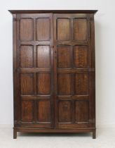 A panelled oak single wardrobe in the 18th century style - early 20th century, the flared, ogee