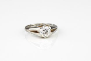 A platinum and diamond solitaire ring - unmarked, tests as platinum, the old brilliant cut diamond