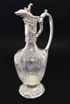 A 19th century claret jug with decorative floral swagged engraving to the lobed, comb-cut glass
