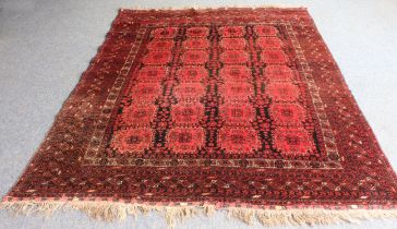 An Afghan rug - possibly Khal Mohammadi, with four rows of seven square madder medallions on a black