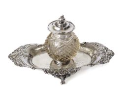 An Edwardian silver inkstand - William Comyns, London 1901, shaped oval form with floral scroll