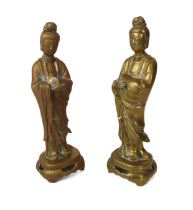 A pair of Chinese brass figures of Guanyin - mid-20th century, 20.5cm. high, both lack the left