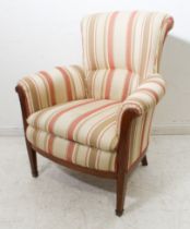 An Edwardian strap upholstered and boxwood strung mahogany show wood tub back armchair: raised on