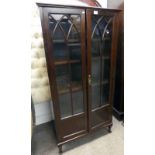 MAHOGANY BOOKCASE WITH ADJUSTABLE SHELVES BEHIND 2 ASTRAGAL GLASS PANEL DOORS ON SHORT QUEEN ANNE