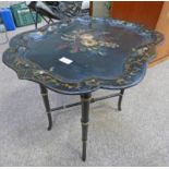 BLACK & GILT LACQUER TRAY WITH PAINTED FLORAL DECORATION ON STAND,