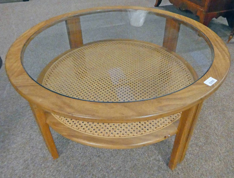 G-PLAN TEAK CIRCULAR COFFEE TABLE WITH GLASS INSET TOP AND BERGERE UNDERSELF.