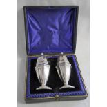 CASED PAIR OF SILVER OCTAGONAL PEPPERS,