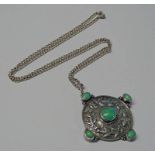 EARLY 20TH CENTURY ARTS & CRAFTS SILVER CIRCULAR PENDANT WITH FLORAL EMBOSSED DECORATION AND INSET