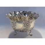 SILVER BOWL WITH FOLIATE DECORATION ON SHAPED SUPPORTS, BIRMINGHAM 1905 - 11 CM DIAMETER,