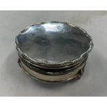 SILVER CIRCULAR JEWELLERY BOX ON 3 SUPPORTS WITH PADDED INTERIOR,