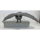 PLASTER MODEL OF A OWL WITH WINGS OUT PERCHED ON A SOLID GRANITE PLINTH,