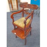 20TH CENTURY MAHOGANY CHILD'S HIGH CHAIR WITH DECORATIVE CARVED BACK ON SABRE SUPPORTS,