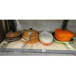 VARIOUS LE CREUSET WARE ON ONE SHELF Condition Report: All the brown coloured ware