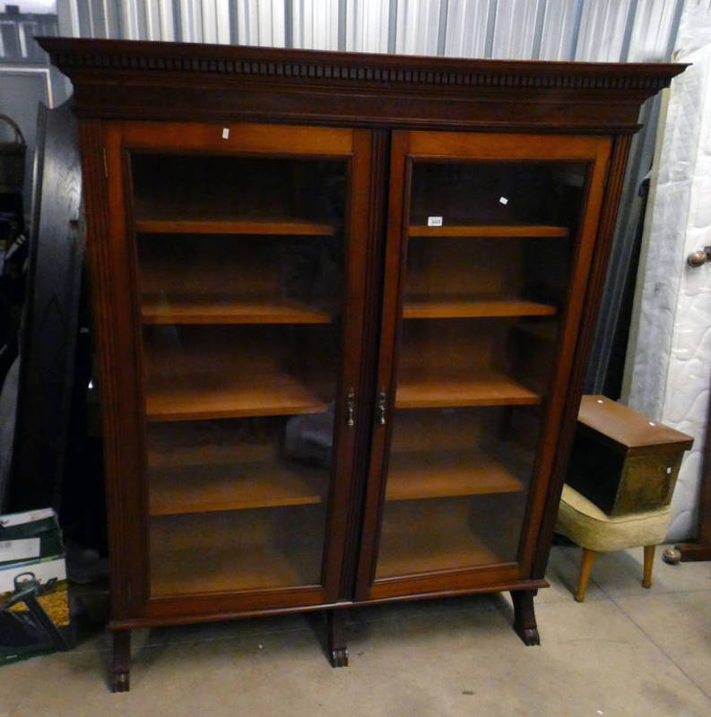 MAHOGANY BOOKCASE WITH ADJUSTABLE SHELVES BEHIND 2 GLAZED PANEL DOORS.