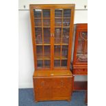 MID 20TH CENTURY OAK BOOKCASE WITH ADJUSTABLE SHELVES BEHIND 2 GLAZED PANEL DOORS OVER BASE WITH 2