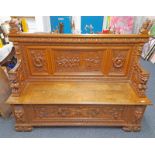 19TH CENTURY STYLE CARVED OAK SETTLE WITH CLASSICAL SCENE PANEL BACK, GRIFFIN ARMS & LIFT SEAT.