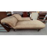 19TH CENTURY CARVED MAHOGANY FRAMED CHAISE LONGUE ON REEDED SUPPORTS.