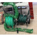 TWO GARDEN HOSES WITH REELS AND ONE OTHER -3-