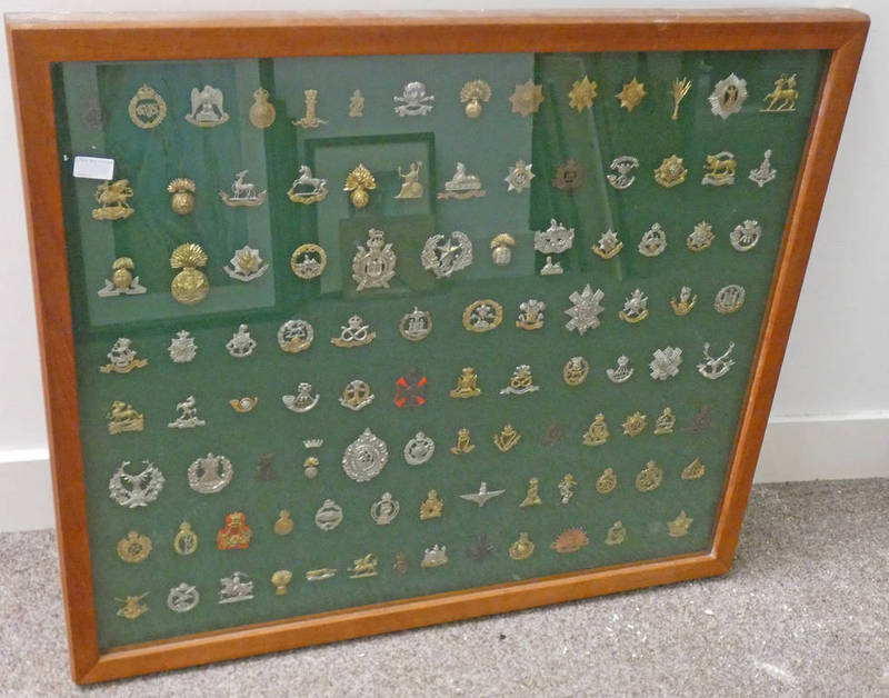 BRITISH ARMY CAP BADGES IN A LARGE GLAZED WALL CASE, BADGES INCLUDE CAVALRY, INFANTRY,