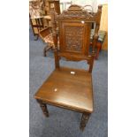 OAK HALL CHAIR WITH DECORATIVE CARVED PANEL BACK ON TURNED SUPPORTS